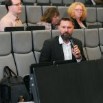 Účastníci konferencie, interiér, prednášky a diskusie