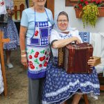 účasníci krajanského dvora, mnohí v krojoch, fotky zachytávajú neformálnu atmosféru